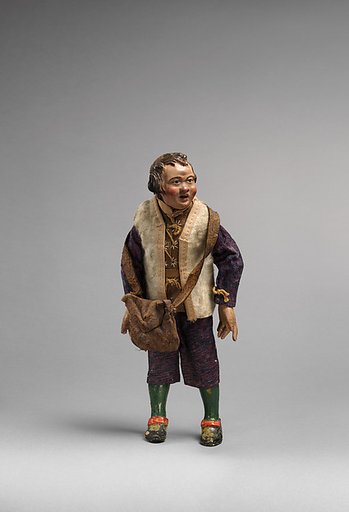 Small man with white furry vest, blue/purple suit, green painted leggings