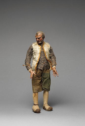Bearded “Innkeeper” with white furry vest, black/white shirt, brown knickers