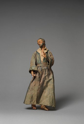 Small “Joseph” with hand raised in purple/grey long robes