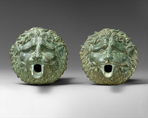 Bronze water spout in the form of a lion mask (one of a pair)