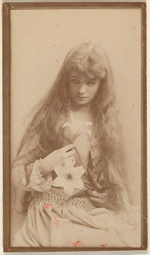 Actress with long hair seated with flower on lap, from the Actresses series (N668)