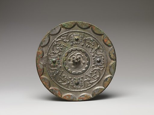 Mirror with dragons and knob-and-swirl design