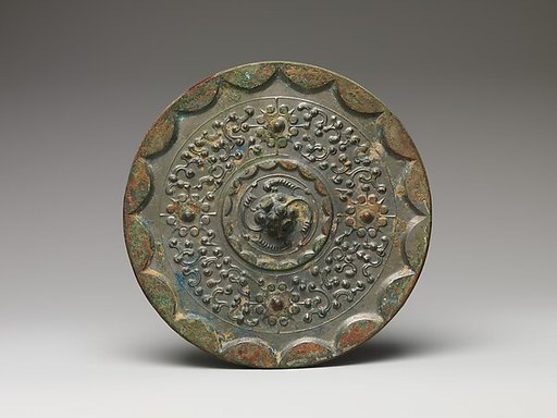 Mirror with dragons and knob-and-swirl design