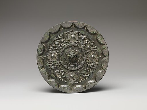 Mirror with dragons and knob-and-swirl design