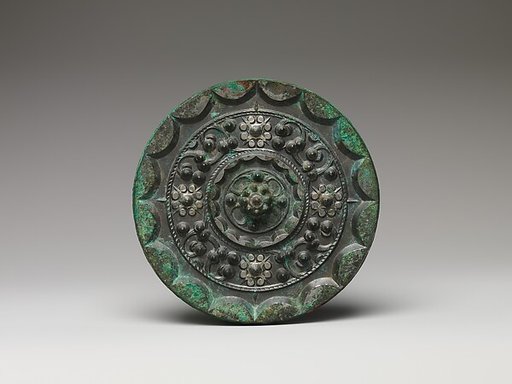 Mirror with dragons and knob-and-swirl design