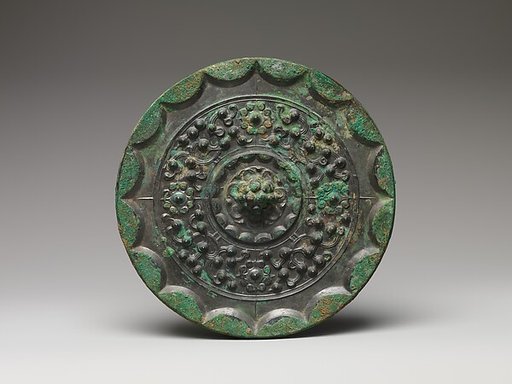 Mirror with dragons and knob-and-swirl design