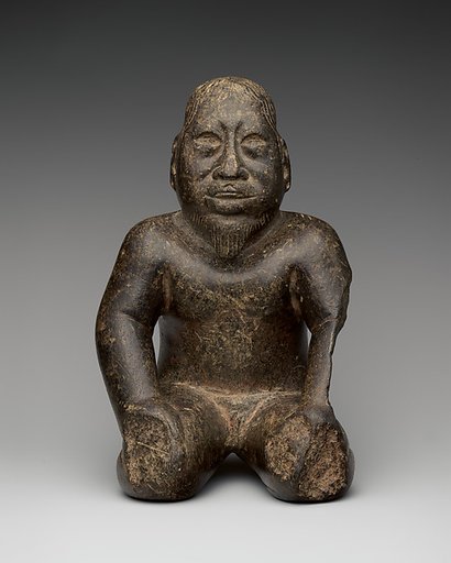 Kneeling bearded figure