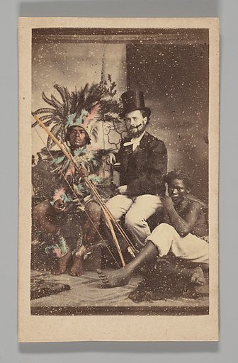 [Studio Portrait: Man Wearing Top Hat Seated with 2 Indigenous People]