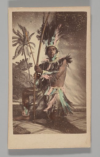 [Studio Portrait: Indigenous Man Seated Holding Bow]