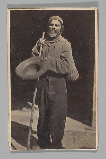 [Studio Portrait: Man with Walking Stick Begging (?)]
