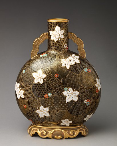 Moon flask with white flower motif on raised foot with flat handles