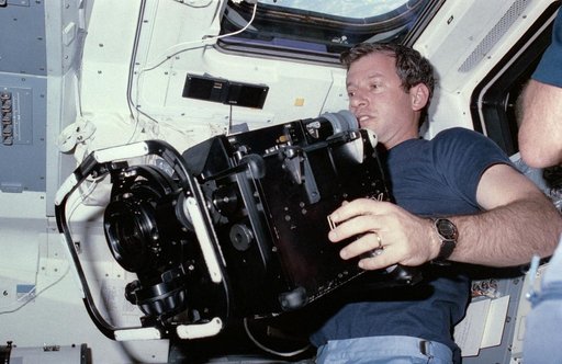 Astronaut Terry Hart prepares to use IMAX camera