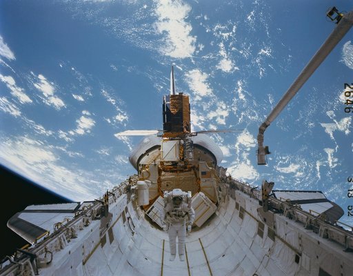 41-C mission specialist repairs captured Solar Maximum Mission Satellite