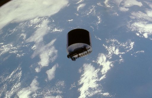View of the Syncom IV satellite in orbit over the earth