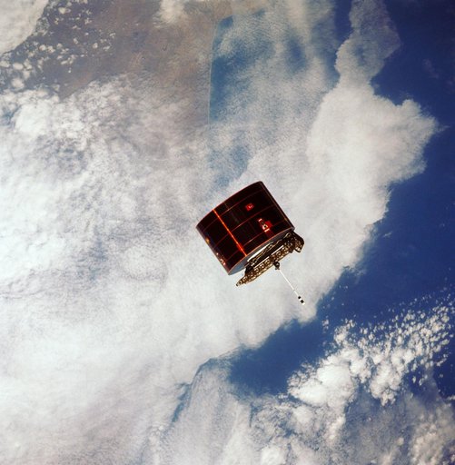 View of the Syncom IV satellite in orbit over the earth