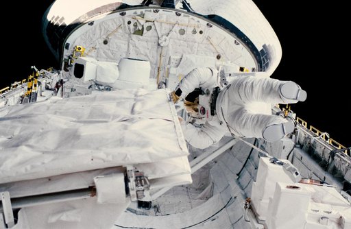 Astronaut Kathryn Sullivan checks SIR-B antenna during EVA