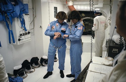 Astronauts Sullivan and Ride synchronize their watches before liftoff