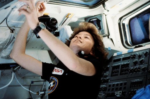 Astronaut Anna Fisher pictured near the aft flight deck of Discovery