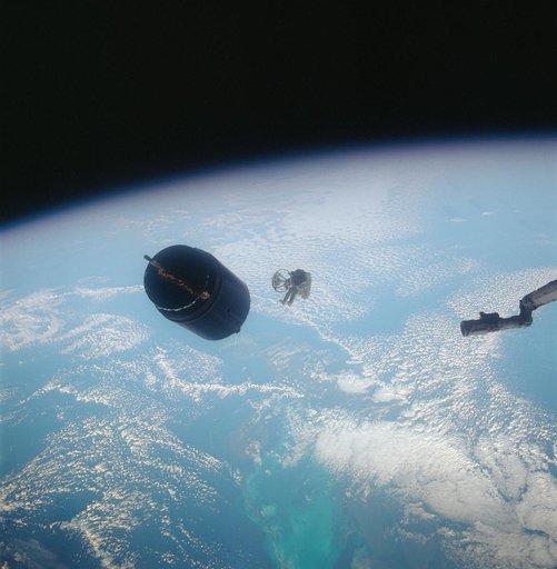 Astronaut Dale Gardner using MMU to travel to Westar VI satellite