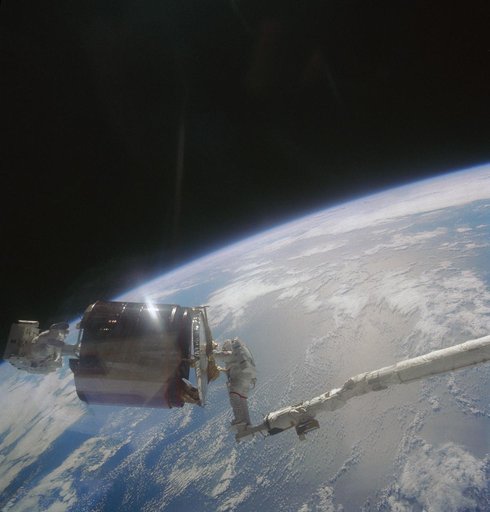 Astronauts Gardner and Allen bringing Westar VI satellite into payload bay