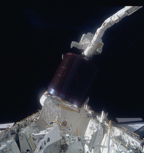 Astronauts Gardner and Allen during loading of Westar VI in payload bay