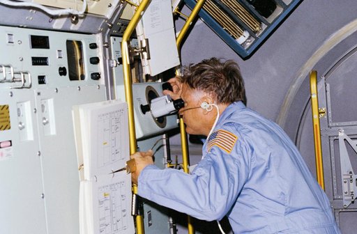 Astronauts Don Lind observes growth of crystals in VCGS aboard orbiter