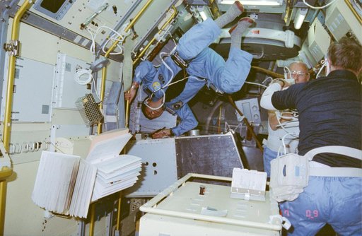 Payload Specialist Taylor Wang performs repairs on Drop Dynamics Module