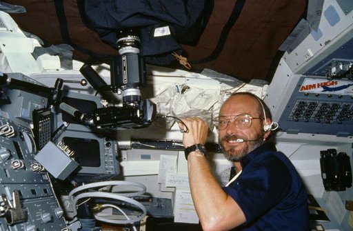 Payload specialist Loren Acton working at aft fligh deck station