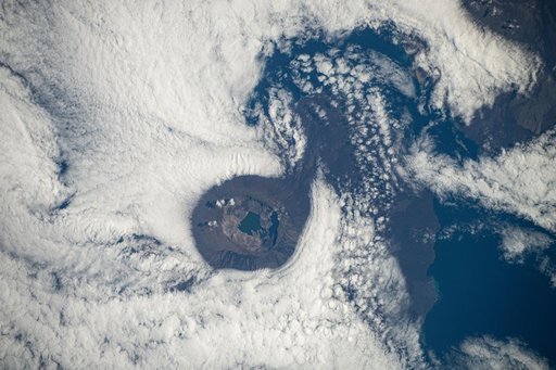 Clouds swirl around a caldera on Fernandina Island