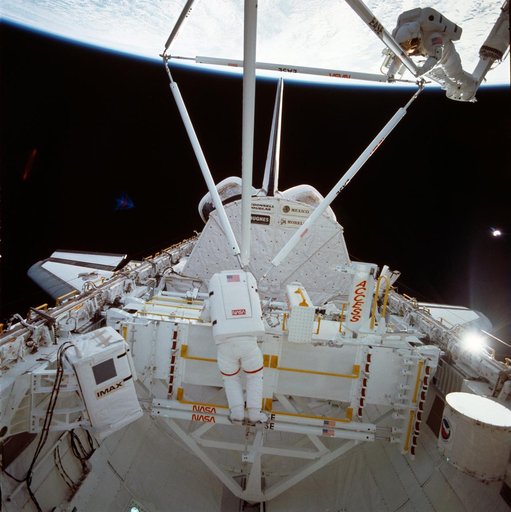 Astronauts Jerry Ross and Sherwood Spring assemble ACCESS components