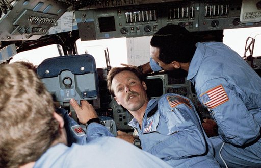 Four STS 61-C crewmembers gather at the commander's station