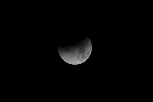 NASA photographer captures Super Blue Blood Moon beginning its eclipse January 31 from NASA's Armstrong Flight Research Center on the West Coast.