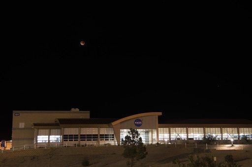 Image shows January 31 Super Blue Blood Moon starting the lunar eclipse over NASA Armstrong Flight Research Center's mission support building located in California.