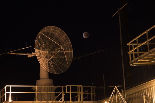 NASA Armstrong Flight Research Center’s communications facility with radar dish and antennas is shown having the eclipsed moon overhead during Jan. 31 Super Blue Blood Moon.