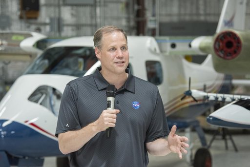 NASA Administrator Bridenstine speaks to press in front of X-57 all electric aircraft that is being modified at Scaled Composites at Mojave Air & Space Port in California