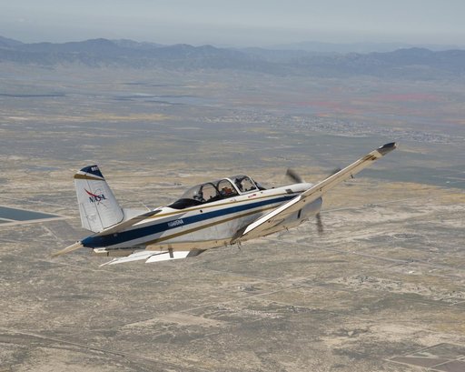 NASA Aircraft heads to Southern California's Poppy Reserve in the foreground. Rainy Season made the Antelope Valley colorful with poppies and wildflowers.