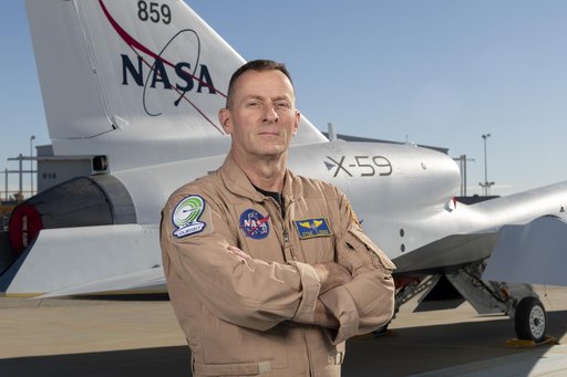 NASA Test Pilot Jim Less Poses with X-59 Research Aircraft