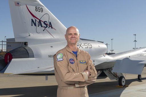 NASA Test Pilot Nils Larson Poses with X-59 Research Aircraft