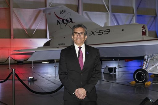 NASA Engineer Poses in Front of Unveiled X-59