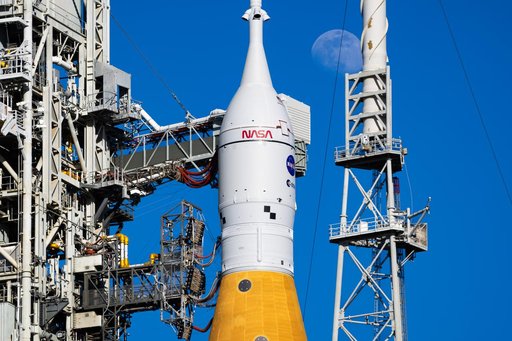 Moon Seen Shining on Full Artemis II Stack at Launch Pad 39B