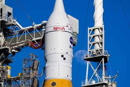 Moon Seen Shining on Full Artemis II Stack at Launch Pad 39B