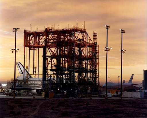 STS-92 - Orbiter in Mate-Demate Device (MDD) at sunrise with Shuttle Carrier Aircraft (SCA) in background