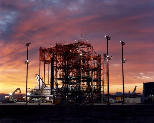 STS-92 - Orbiter in Mate-Demate Device (MDD) at sunrise with Shuttle Carrier Aircraft (SCA) in background