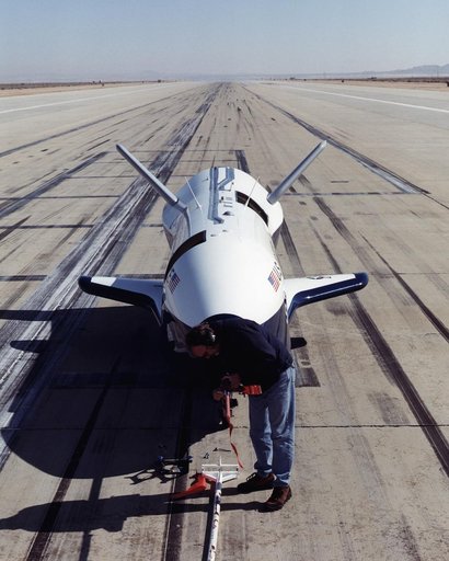 A worker attaches covers for the nose pitot boom before removing the unpiloted X-40 from the runway at Edwards Air Force Base, California, following its successful free-flight on March 14, 2001