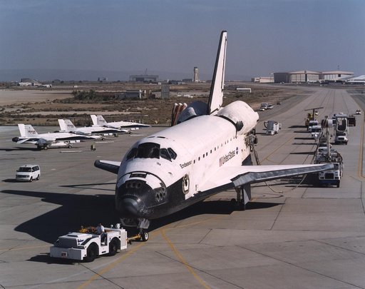 The Space Shuttle Endeavour, accompanied by a convoy of recovery vehicles, is towed up the taxiway at NASA's Dryden Flight Research Center at Edwards Air Force Base, California, following its landing on June 19, 2002.  The landing, the 49th to occur at Ed
