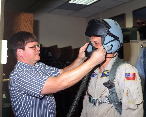 Jeff Greulich, DynCorp life support technician, adjusts a prototype helmet on a NASA Dryden pilot. Five pilots evaluated the helmet for fit, comfort and functionality during the summer and fall of 2002.