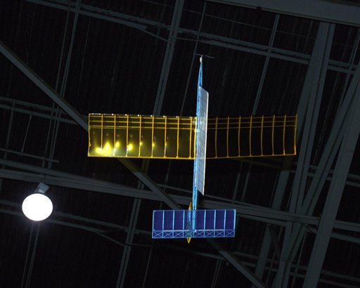 An experimental radio-controlled model aircraft is seen here in flight, powered only by light energy beamed to it by a spotlight.