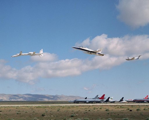 Scaled Composites' Proteus aircraft with an F/A-18 Hornet and a Beechcraft KingAir from NASA's Dryden Flight Research Center during a low-level flyby at Mojave Airport in Southern California.