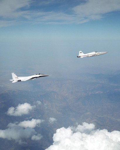 NASA's F-15B research testbed jet flew in the supersonic shockwave of a Northrop Grumman Corp. - modified U.S. Navy F-5E jet in support of the Shaped Sonic Boom Demonstration project.
