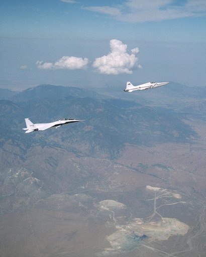 NASA's F-15B research testbed jet flew in the supersonic shockwave of a Northrop Grumman Corp. - modified U.S. Navy F-5E jet in support of the Shaped Sonic Boom Demonstration project.